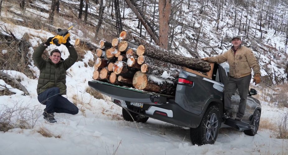 Reviewers stack logs in a Rivian electric truck.