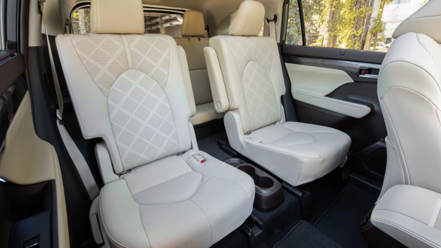 The roomy interior of a Toyota Highlander crossover SUV finished in white leather.