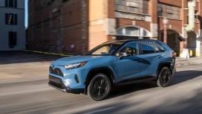 A blue 2022 Toyota RAV4 driving, the RAV4 is a best selling SUV