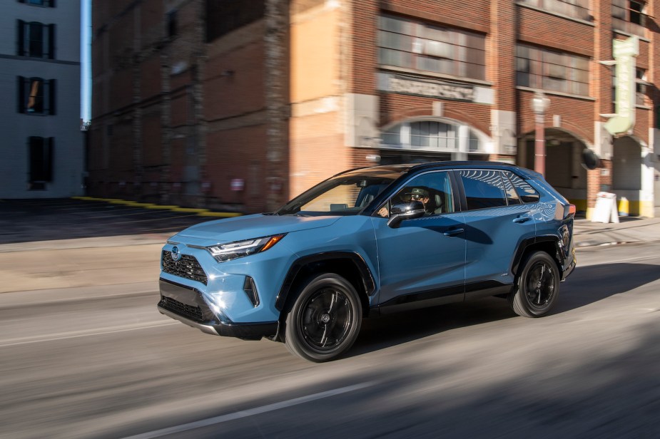 A blue 2022 Toyota RAV4 driving, the RAV4 is a best selling SUV