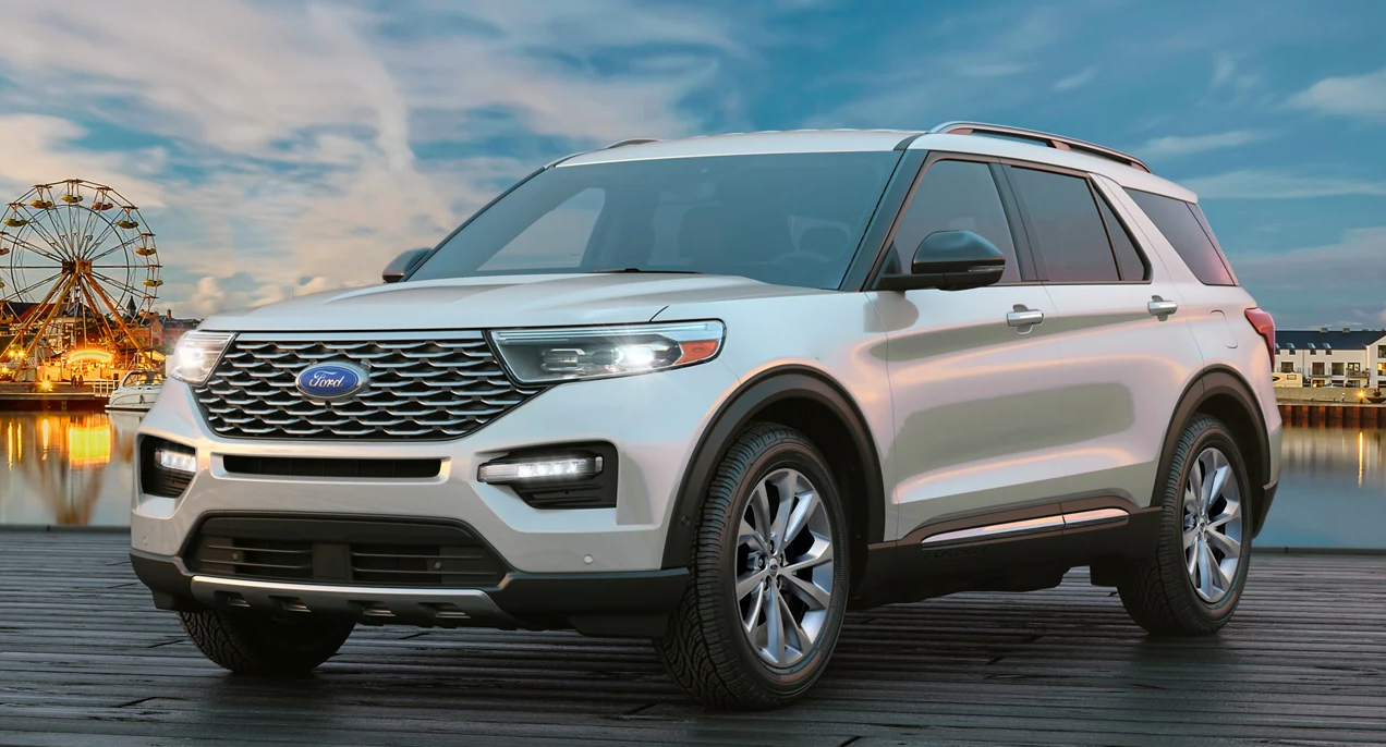 A white 2023 Ford Explorer midsize SUV is parked.