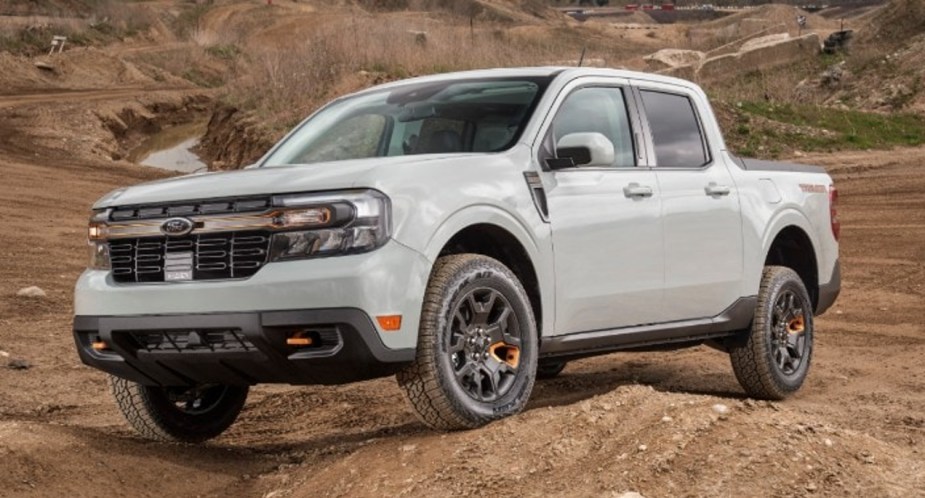 A gray 2023 Ford Maverick small pickup truck is driving off-road.