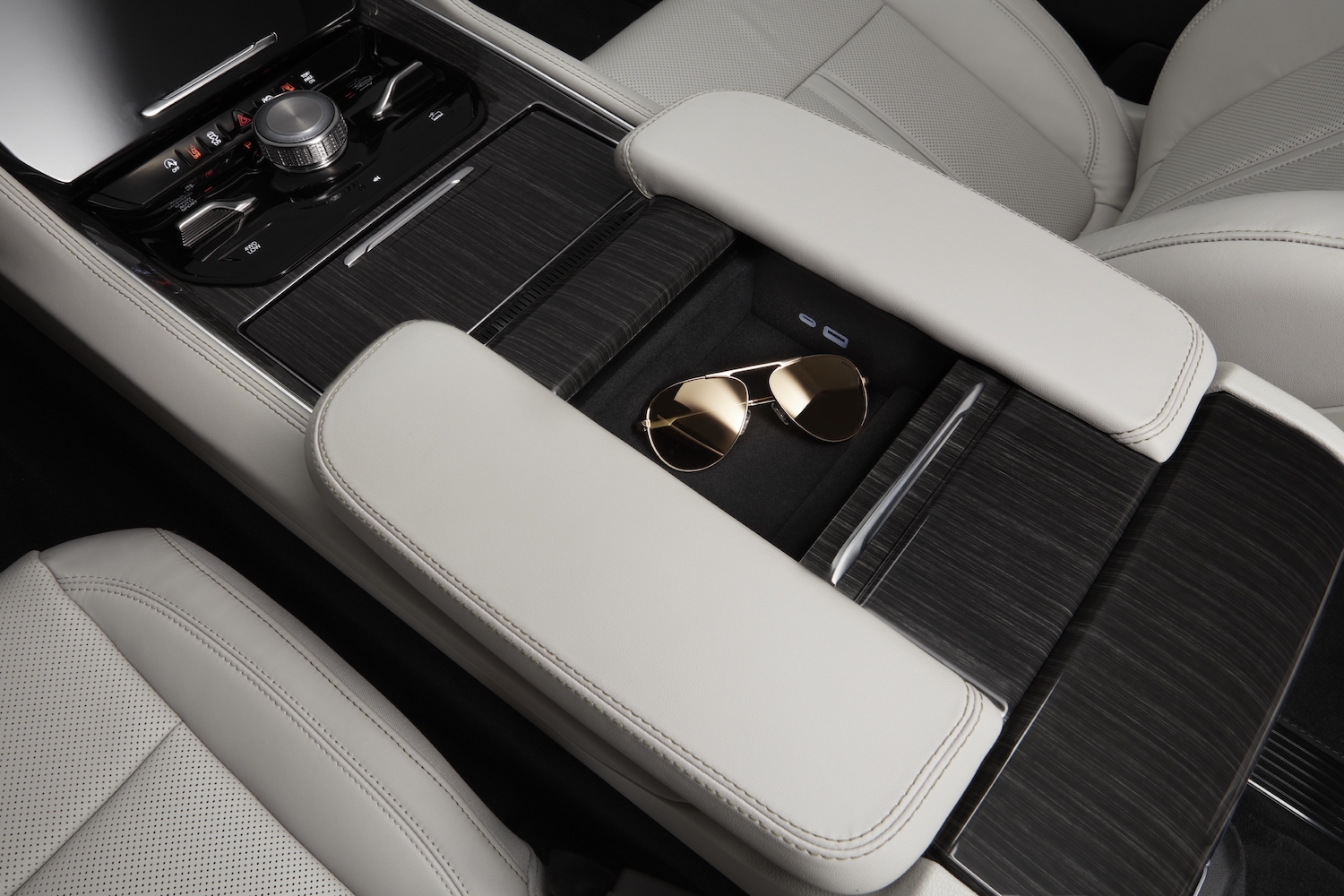 Detail photo of a pair of sunglasses sitting on the center console of an entry-level Gladiator Series I SUV?