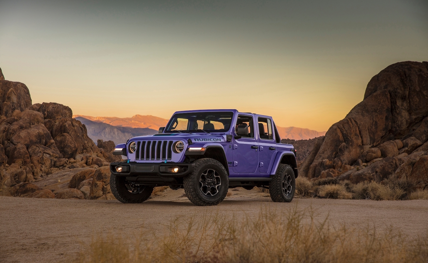 2023 Jeep Wrangler Unlimited SUV in the all-new purple reign color, parked in the desert.
