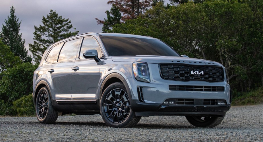 A gray 2023 Kia Telluride midsize SUV is parked outside.