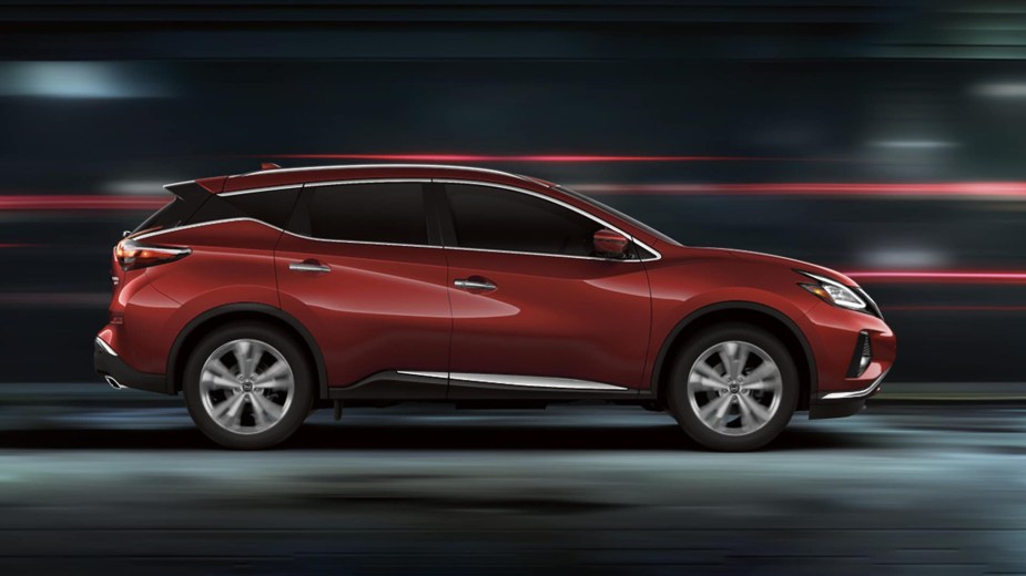 A red 2023 Nissan Murano driving in a blur. It's the worst selling midsize SUV in dead last for Q3 2022. 