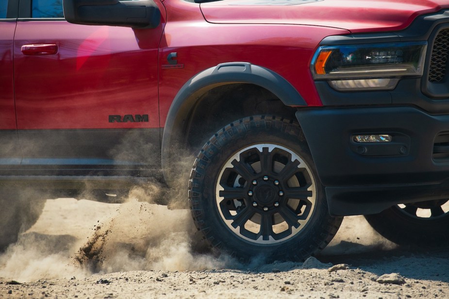 Closeup of the tire of a heavy-duty Ram 2500 off-road pickup truck driving off-road.
