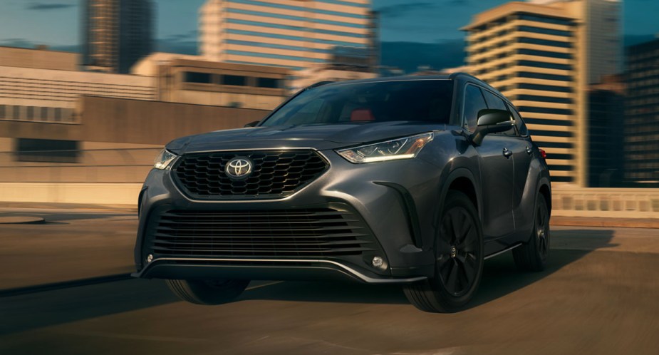 A gray 2023 Toyota Highlander midsize SUV is parked.