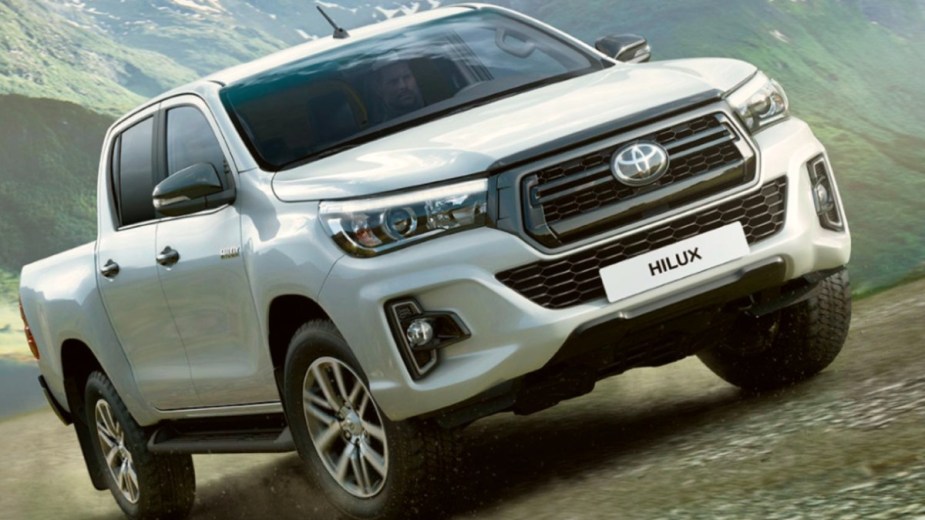White 2023 Toyota Hilux riding on a trail