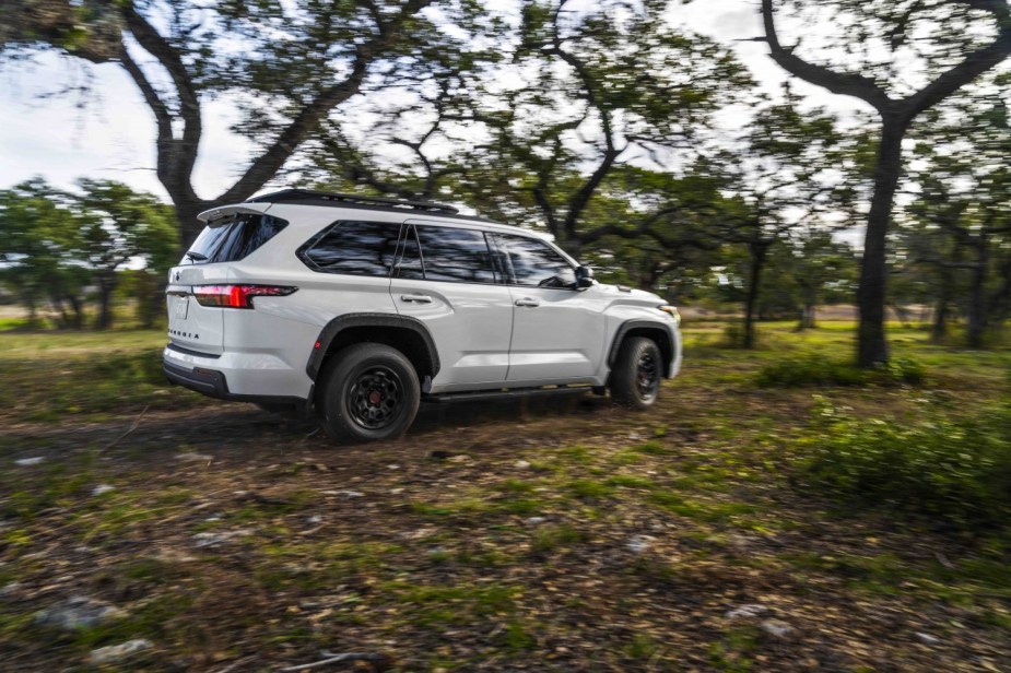 White Toyota Sequoia TRD driving off-road for a promo photo.