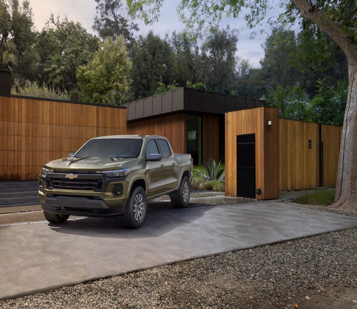 2023 Chevy Colorado in brown parked at a modern house