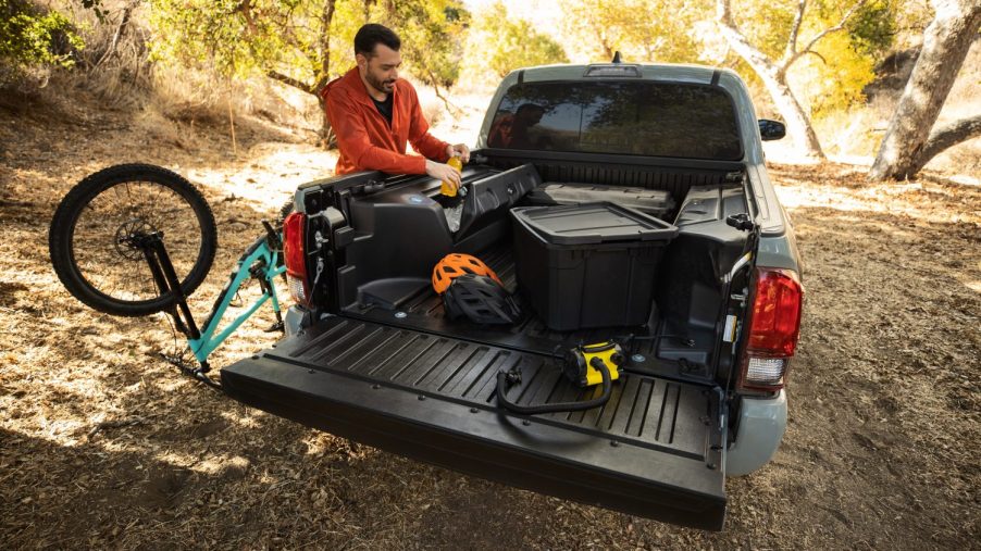 A Toyota Tacoma with bicycles and tools in the bed