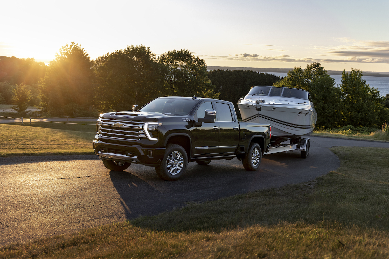 Front 3/4 view of the 2024 Chevrolet Silverado HD High Country towing a boat