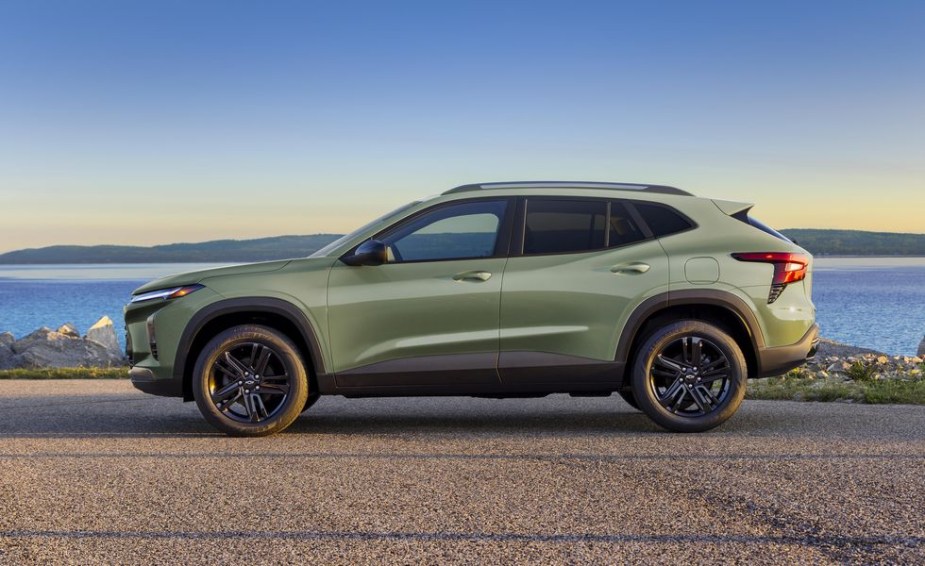 A green 2024 Chevy Trax subcompact SUV is parked near a body of water.