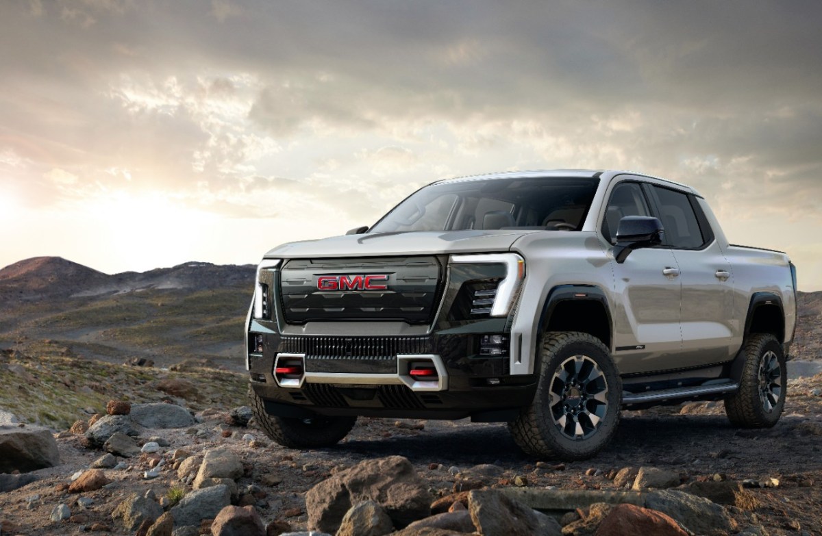 The GMC Sierra EV truck in silver on dirt. GM is reserving the Crab Walk feature for its GMC EV trucks.  