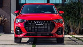 A red Audi Q3 luxury subcompact SUV is parked.