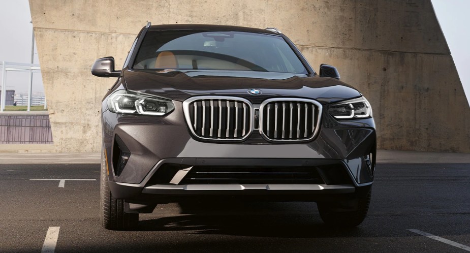 A gray BMW X3 small luxury SUV is parked. 