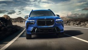 A blue 2023 BMW X7 three-row SUV drives on a road during the day. What's new with it?