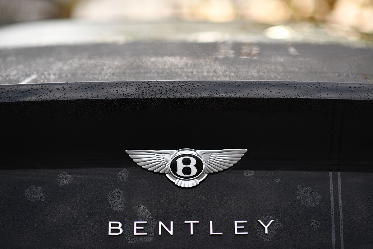 A Bentley Continental badge shines on a black deck lid.
