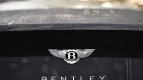 A Bentley Continental badge shines on a black deck lid.