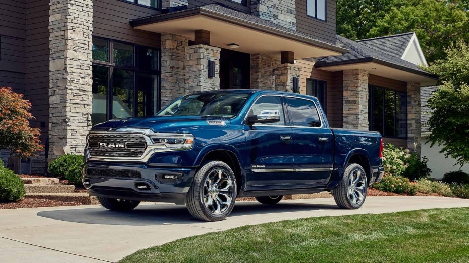 Blue 2023 Ram 1500 parked in front of a house