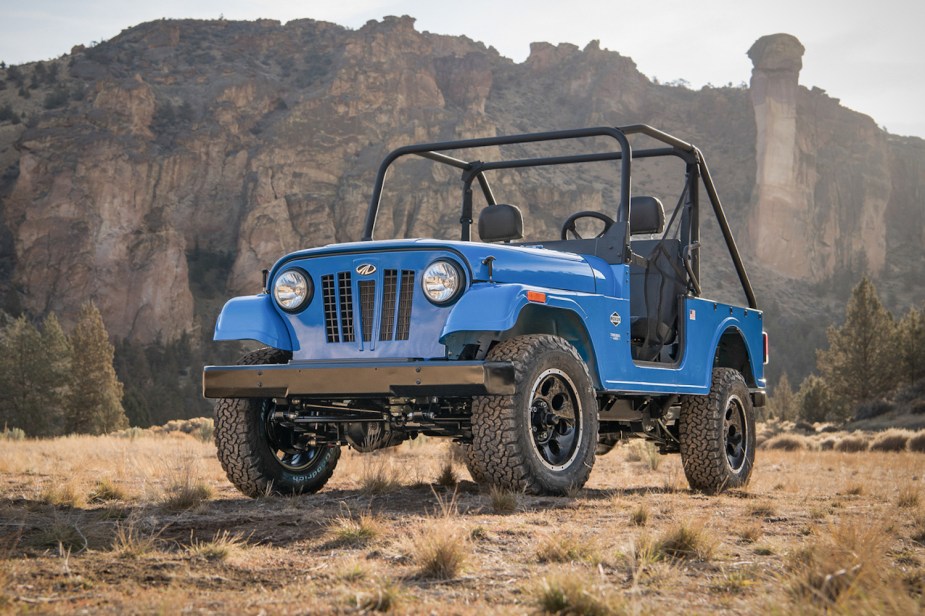 Advertising photo of an electric blue Roxor 4x4 side-by-side vehicle built by Mahindra. This concept is shaped like a Willys Jeep.