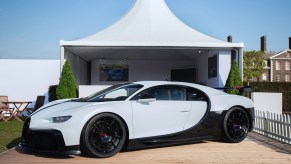 A white Bugatti Chiron Pur Sport, one of the least fuel efficient cars, parked outdoors.