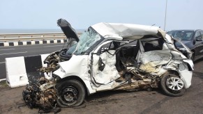 A white car involved in a car accident who hopefully knows what liability limit means.