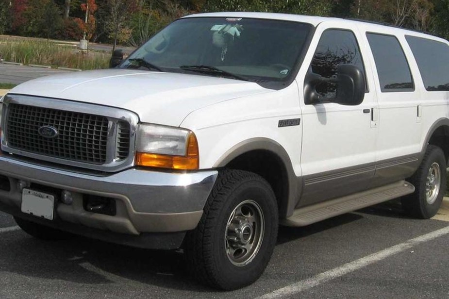 White Ford Excursion parked, this was one of the worst Fords ever made