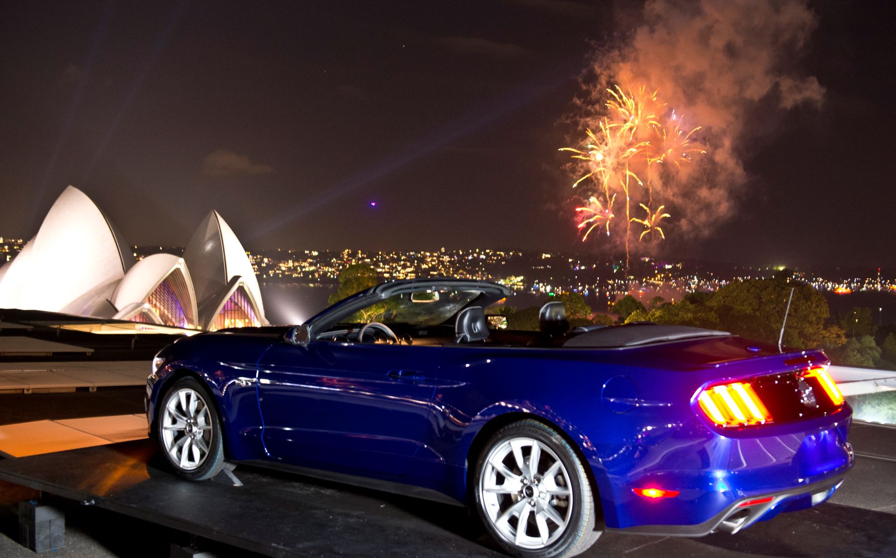 A blue Ford Mustang muscle car parked on New Year's Eve in Sydney, Australia