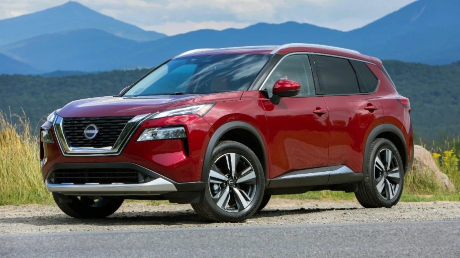 Front angle view of Scarlet Ember Tintcoat 2023 Nissan Rogue crossover SUV