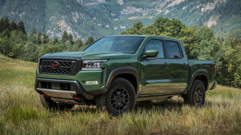 Front angle view of Tactical Green Metallic 2023 Nissan Frontier midsize pickup truck, it may offer wireless Apple CarPlay.