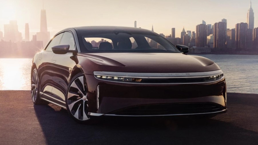 Front angle view of maroon 2023 Lucid Air, electric car alternative that costs less than Tesla Model S