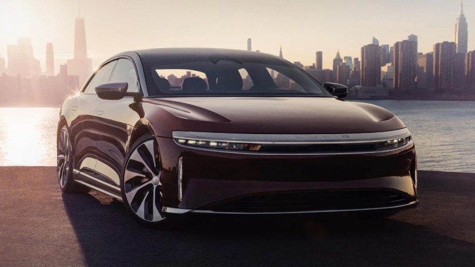 Front angle view of maroon 2023 Lucid Air, electric car alternative that costs less than Tesla Model S