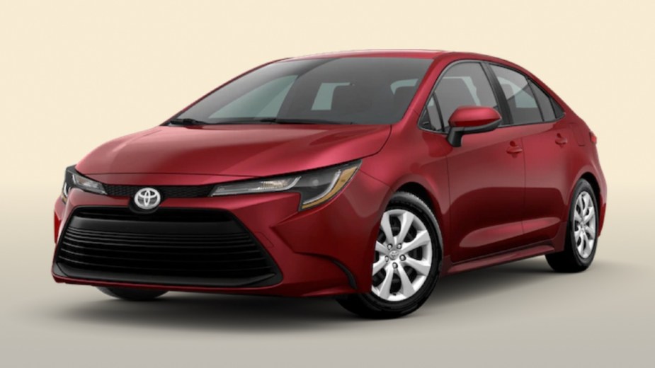 Front angle view of new 2023 Toyota Corolla Sedan with Ruby Flare Pearl exterior paint color