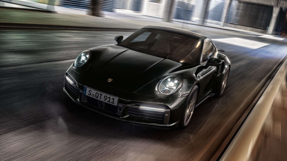 Front angle view of new black 2023 Porsche 911 Turbo S sports car, highlighting how much fully loaded one costs