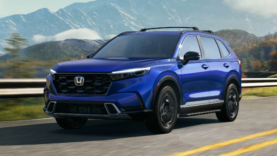 ​​Front angle view of new blue 2023 Honda CR-V crossover SUV, highlighting how much a fully loaded one costs