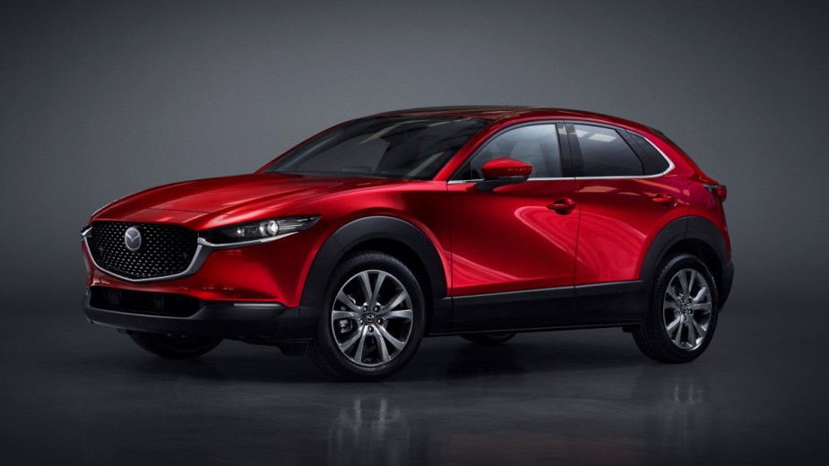 Front angle view of new red 2023 Mazda CX-30 crossover SUV, highlighting its price and release date
