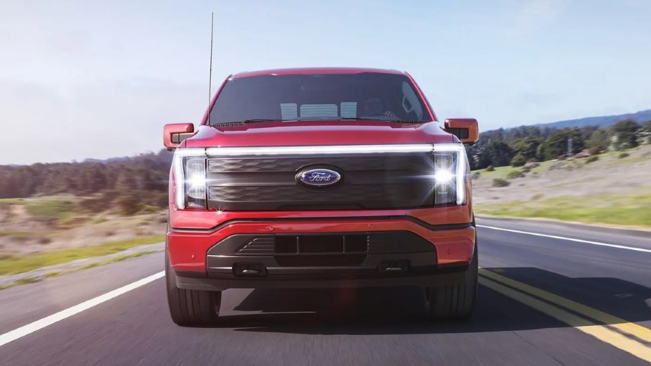 Front angle view of red 2023 Ford F-150 Lightning electric pickup truck