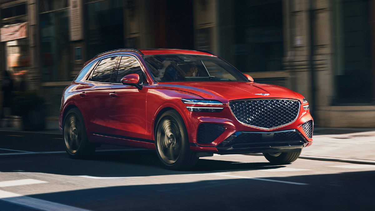 Front angle view of red 2023 Genesis GV70, more affordable 2023 BMW X3 luxury SUV alternative costing under $45,000