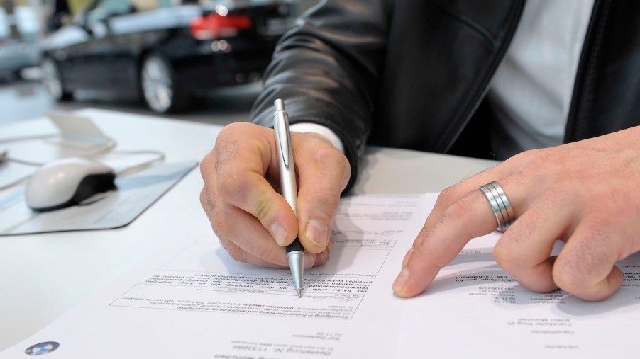 A customer signs a contract for a new car.