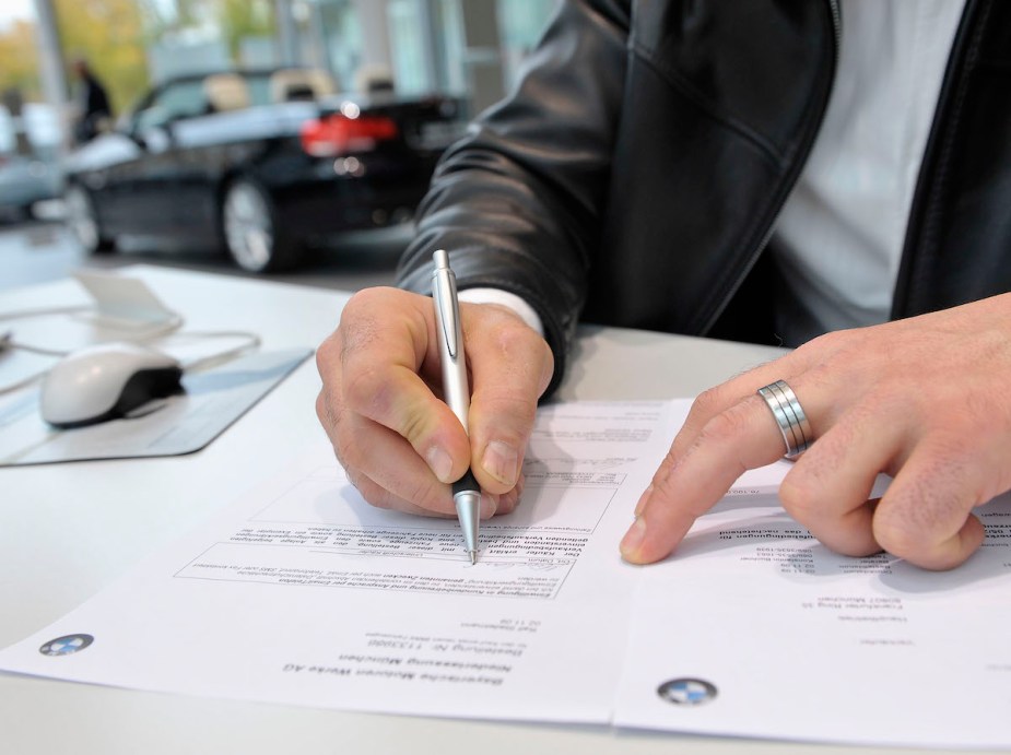 A customer signs a contract for a new car.