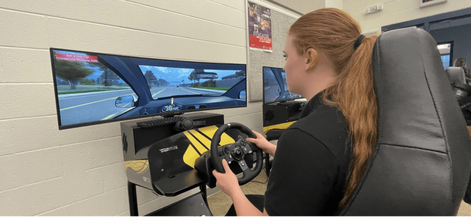 A teenager trains driving skills using simulators provided by organizations funded by Honda for teen driver safety.