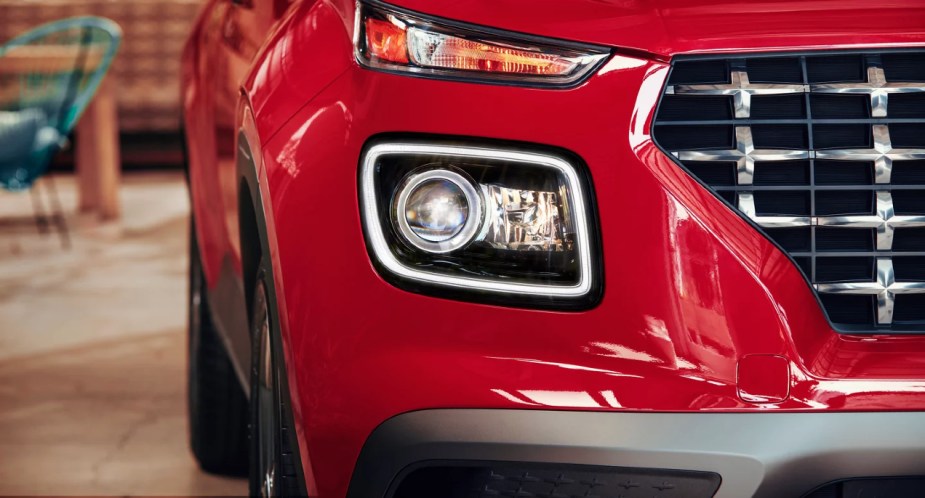 The front left side of a red 2022 Hyundai Venue subcompact SUV. 