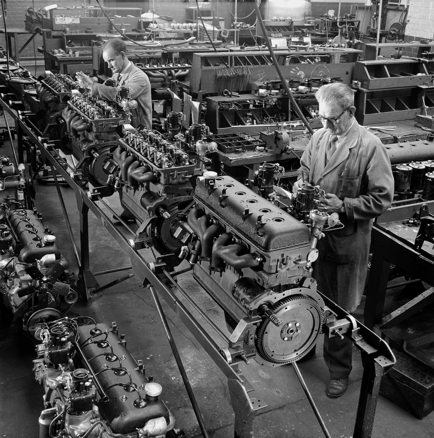 Workers in the Armstrong Siddeley factory assemble a line of inline six-cylinder I6 engines for saloon cars.