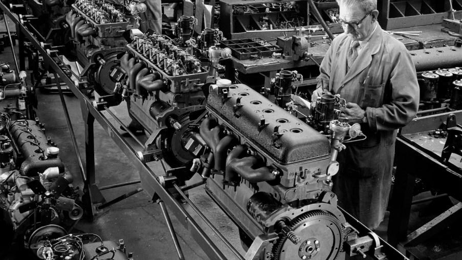 Workers in the Armstrong Siddeley factory assemble a line of inline six-cylinder I6 engines for saloon cars.