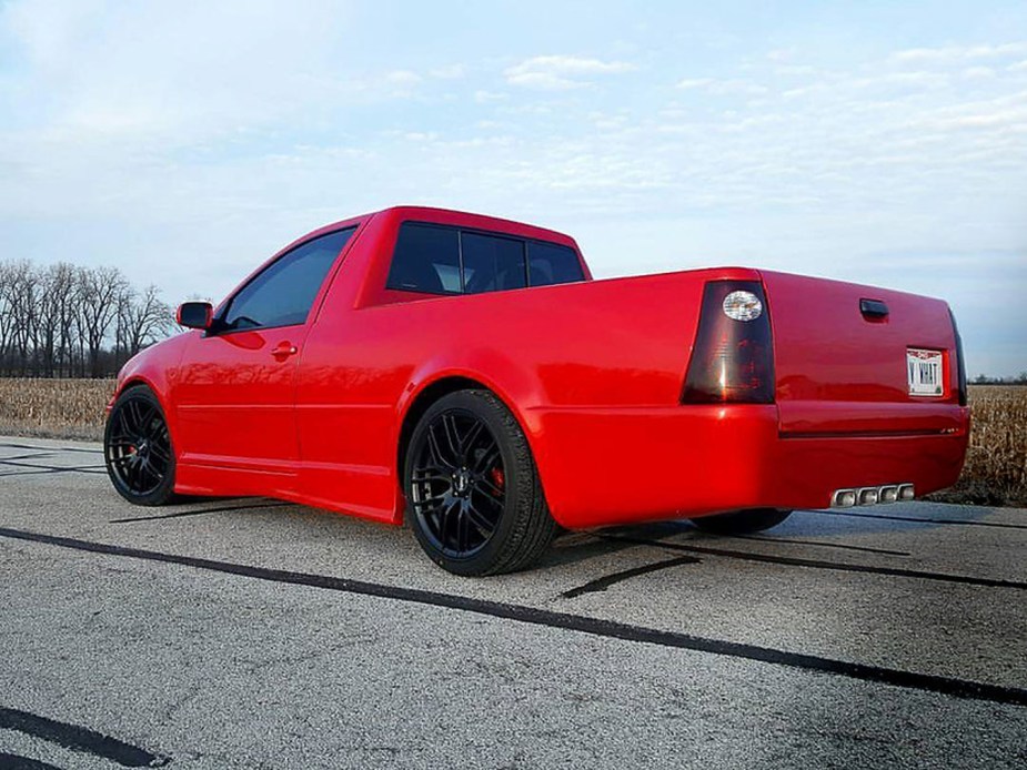 A red VW Jetta that has been converted into a ute for added practicality. 