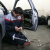A mechanic works on a window assembly passenger door. How much does it cost to replace a car window motor?