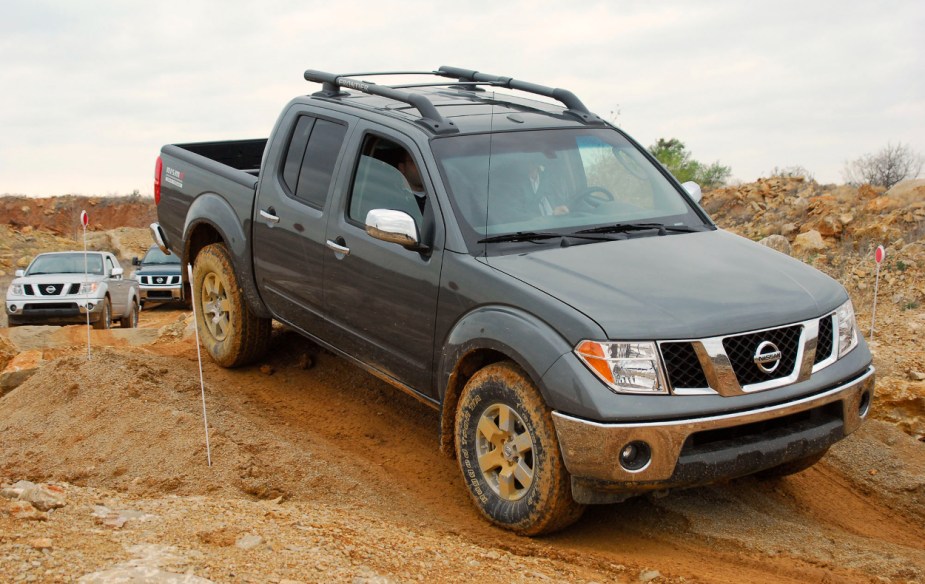 Nissan's mid-size truck, the Frontier is shown off-roading in a remote area.