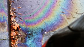 A rainbow oil stain from an oil leak where someone needs to clean up an oil spill.